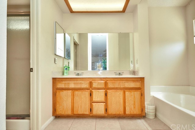 471 Silverado Street Barstow, CA 92311 - Photo 30 of 43 a spacious bathroom with a tub sink and mirror