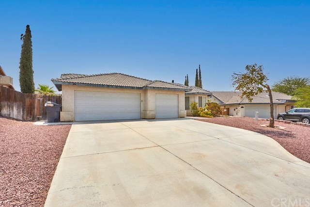 471 Silverado Street Barstow, CA 92311 - Photo 3 of 43 a front view of a house with a yard and garage