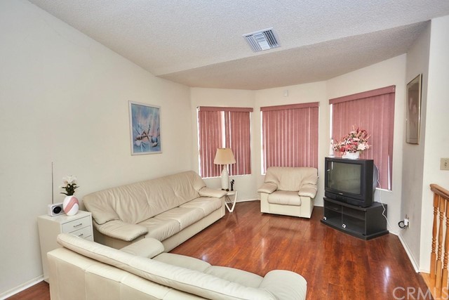 471 Silverado Street Barstow, CA 92311 - Photo 4 of 43 a living room with furniture and a flat screen tv