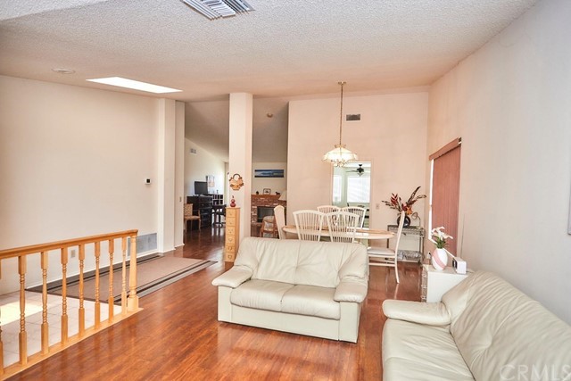 471 Silverado Street Barstow, CA 92311 - Photo 5 of 43 a living room with furniture and a chandelier