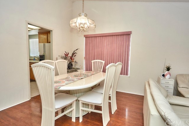 471 Silverado Street Barstow, CA 92311 - Photo 7 of 43 a dining room with furniture a chandelier and wooden floor