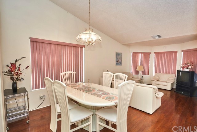 471 Silverado Street Barstow, CA 92311 - Photo 8 of 43 a view of a dining room with furniture window and wooden floor