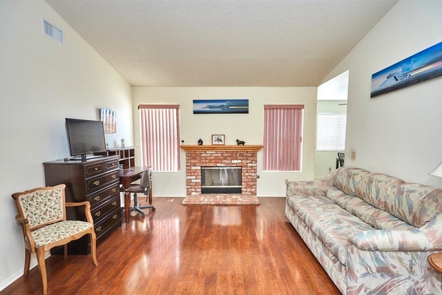 471 Silverado Street Barstow, CA 92311 - Photo 10 of 43 a living room with furniture and a flat screen tv