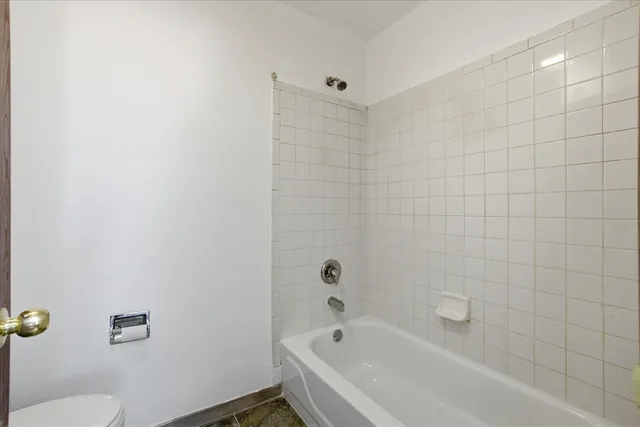 a bathroom with a bathtub and toilet