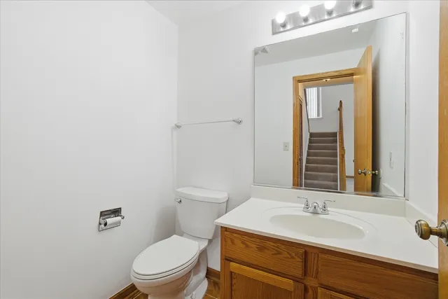 a bathroom with a toilet a sink and mirror