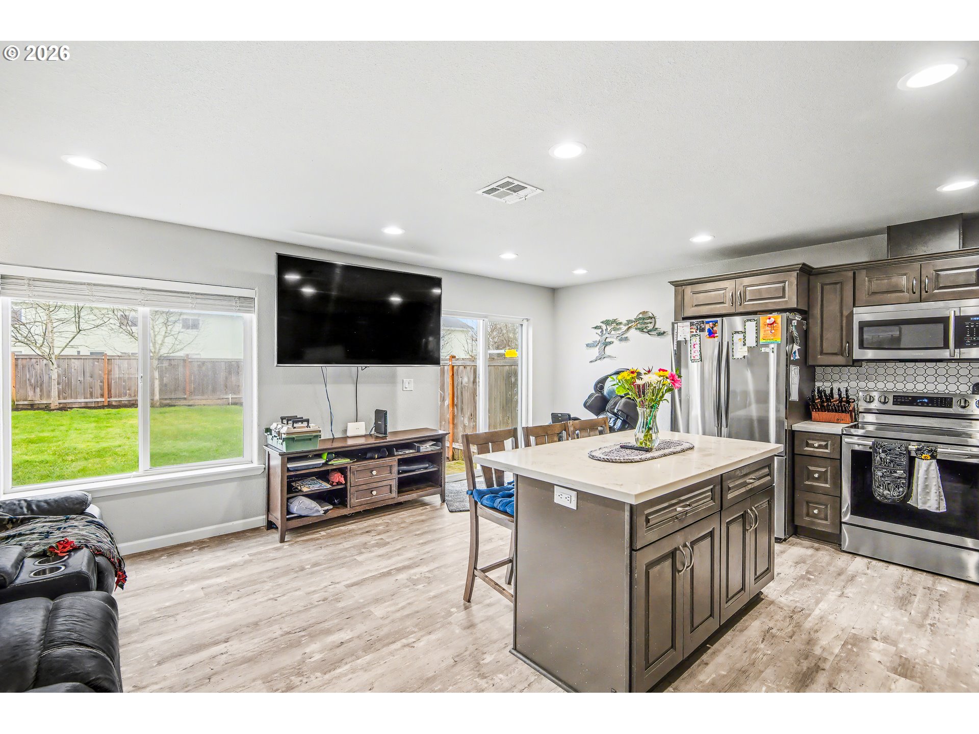 88192 Jameson Way Veneta, OR 97487 - Photo 29 of 44 a living room with stainless steel appliances kitchen island furniture and a flat screen tv