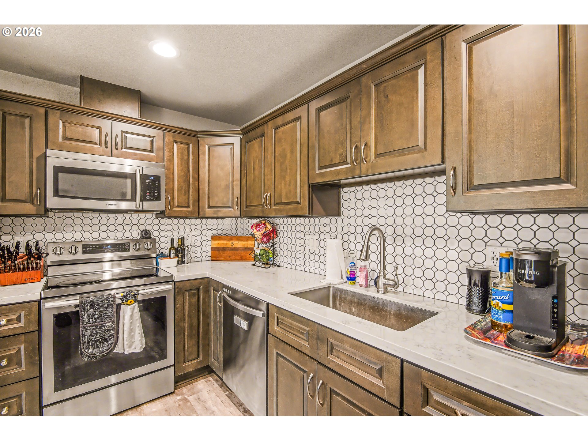 88192 Jameson Way Veneta, OR 97487 - Photo 31 of 44 a kitchen with stainless steel appliances granite countertop a sink stove and microwave