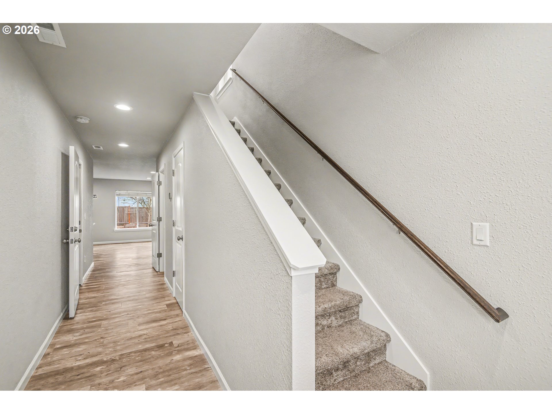 88192 Jameson Way Veneta, OR 97487 - Photo 4 of 44 a view of a hallway with wooden floor and staircase