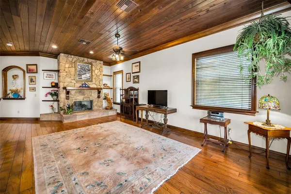 a room with wooden floor and furniture