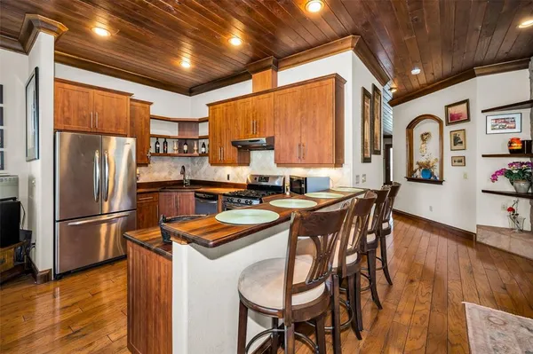 a room with a table chairs and a stove
