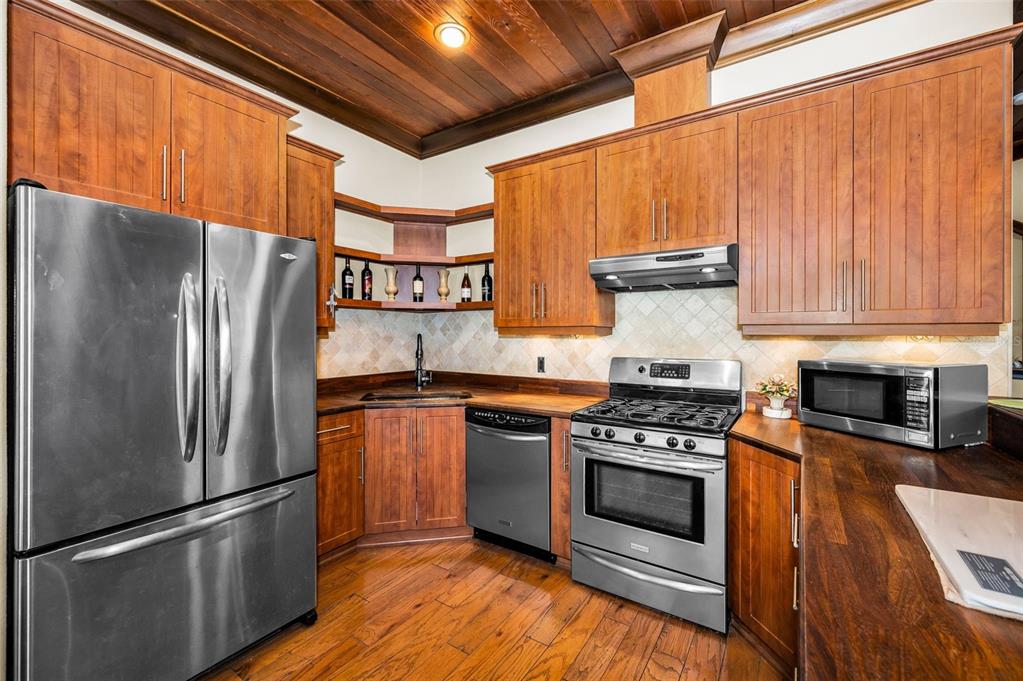6141 Lafayette Street New Port Richey, FL 34652 - Photo 16 of 98 a kitchen with stainless steel appliances granite countertop a refrigerator stove and sink