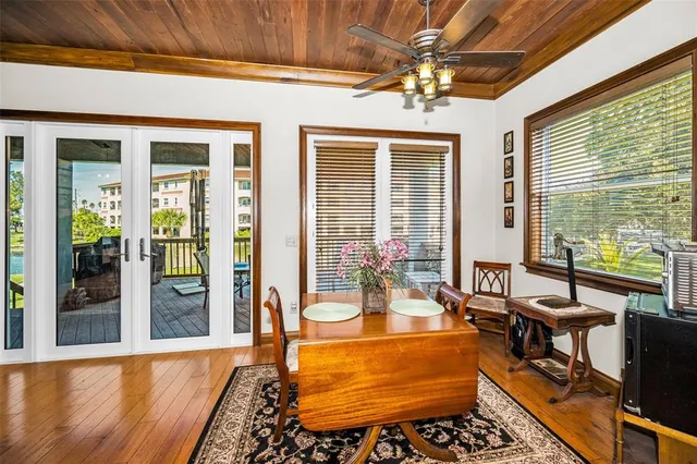 a dining room with wooden floor and outdoor space