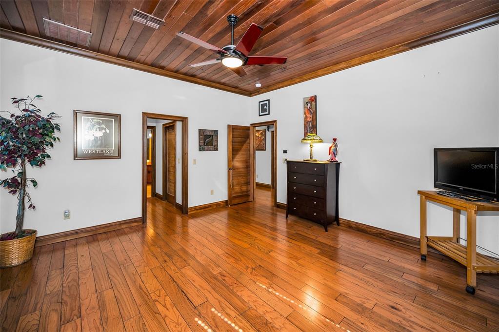 6141 Lafayette Street New Port Richey, FL 34652 - Photo 26 of 98 a room with wooden floor and furniture