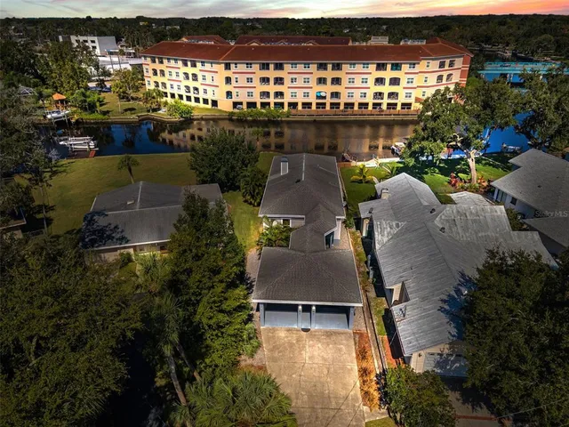 an aerial view of residential houses with outdoor space and parking