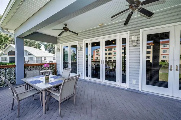 a view of house with yard and lake in background