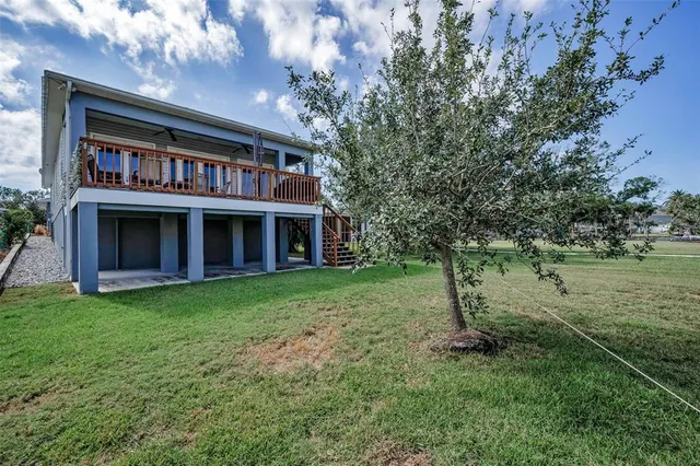 a view of a patio with table and chairs under an umbrella
