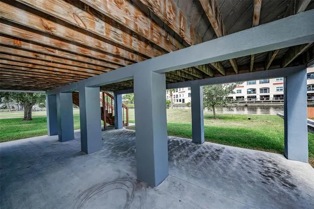 a view of a park with trees and wooden fence