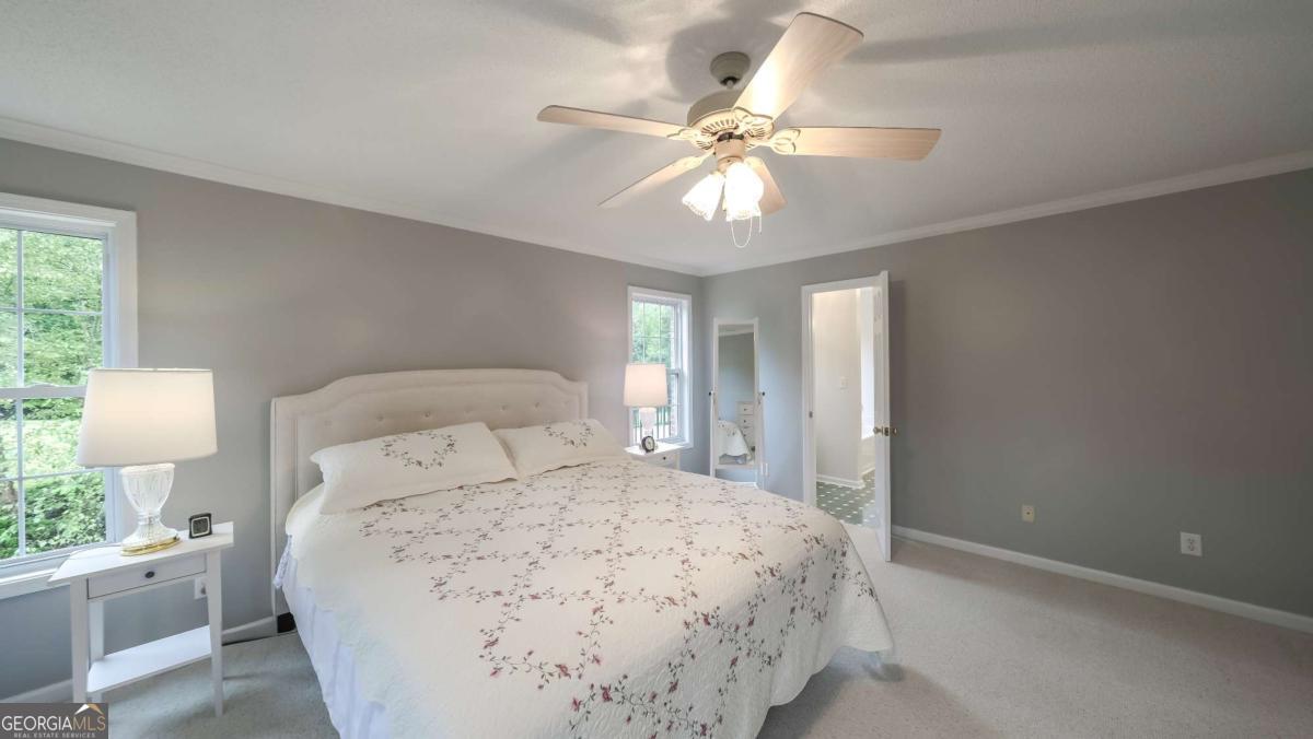 45 Buell Jones Road Carrollton, GA 30117 - Photo 22 of 60 a bedroom with a large bed and a chandelier