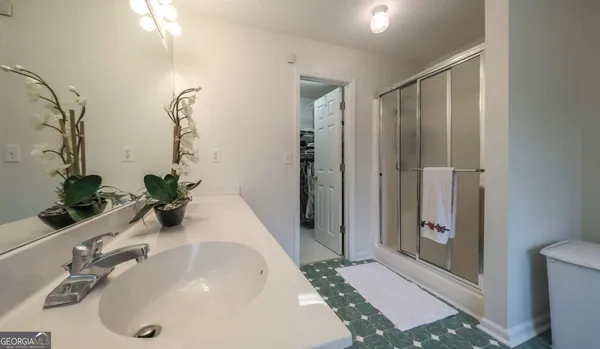 a utility room with a stove a microwave and cabinets