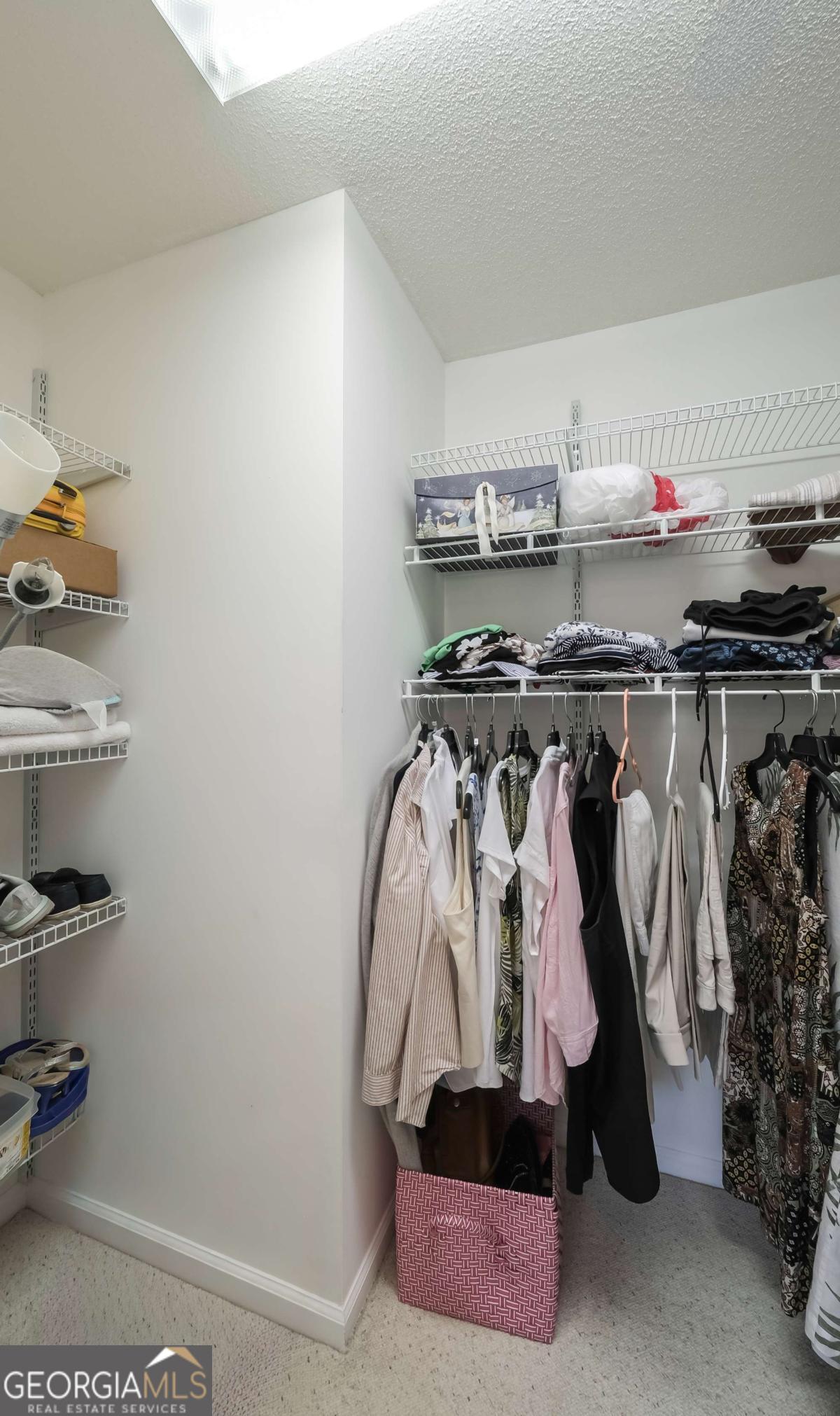 45 Buell Jones Road Carrollton, GA 30117 - Photo 29 of 60 a view of walk in closet with clothes and shoes