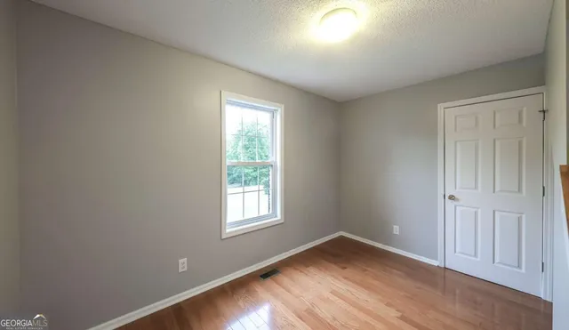 a utility room with a stove a microwave and cabinets