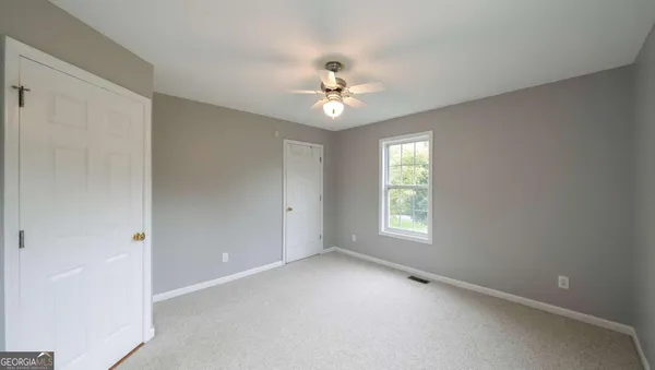 a bathroom with a sink toilet and a mirror
