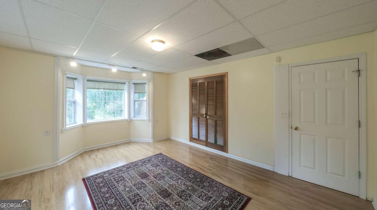 45 Buell Jones Road Carrollton, GA 30117 - Photo 37 of 60 a view of an empty room with a window and wooden floor