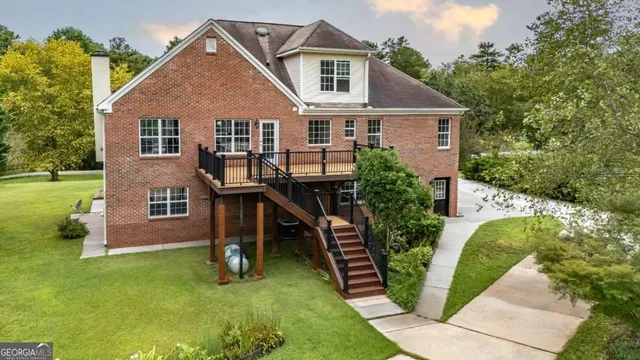 a open kitchen with stainless steel appliances granite countertop a refrigerator a stove a sink dishwasher and a dining table with the view of kitchen