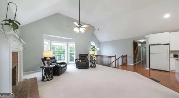 a living room with furniture chandelier and a fireplace