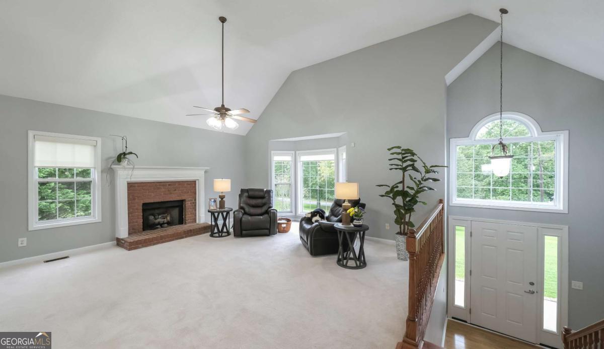 45 Buell Jones Road Carrollton, GA 30117 - Photo 4 of 60 a view of a livingroom with a fireplace and a chandelier