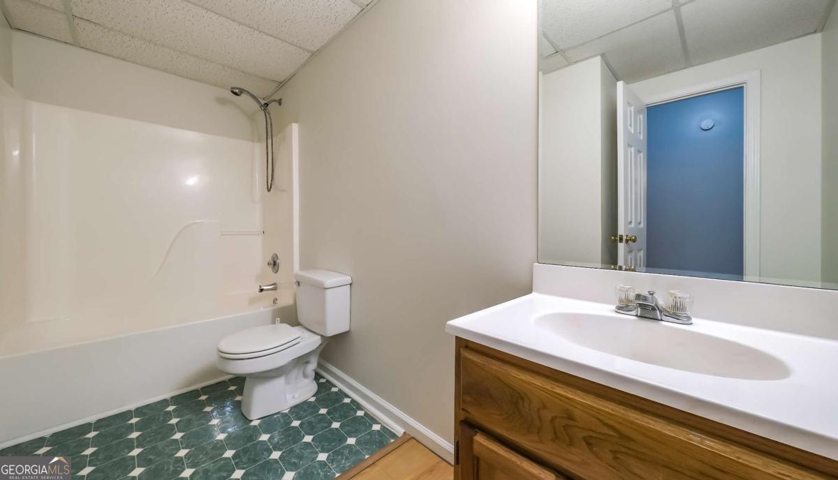 45 Buell Jones Road Carrollton, GA 30117 - Photo 43 of 60 a bathroom with a sink toilet and a mirror