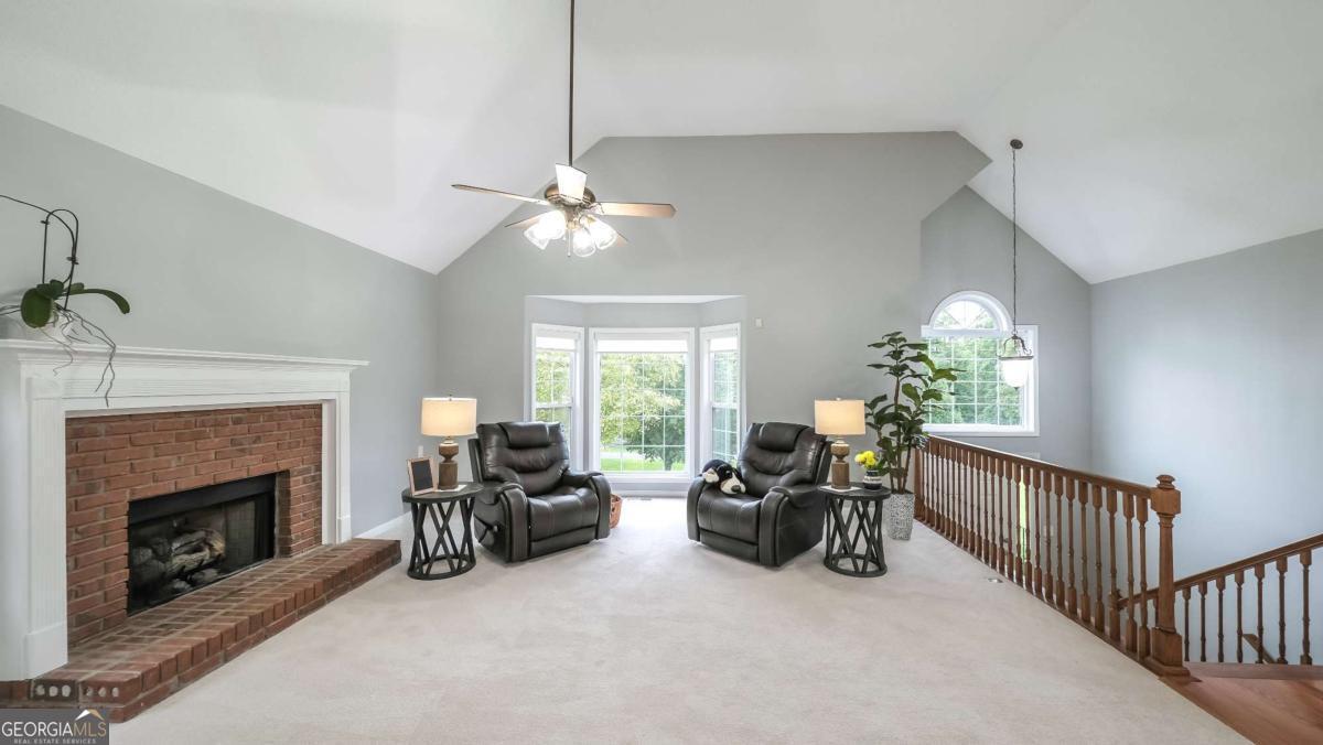 45 Buell Jones Road Carrollton, GA 30117 - Photo 5 of 60 a living room with furniture chandelier and a fireplace