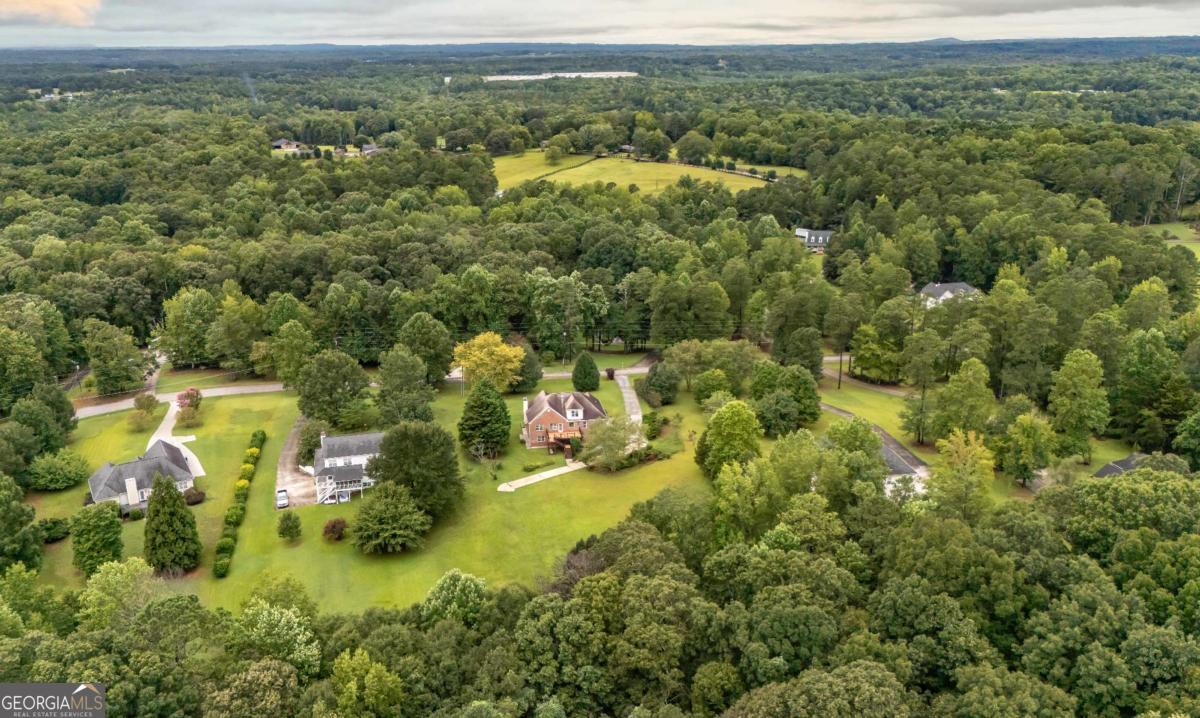 45 Buell Jones Road Carrollton, GA 30117 - Photo 54 of 60 an aerial view of residential houses with outdoor space and trees