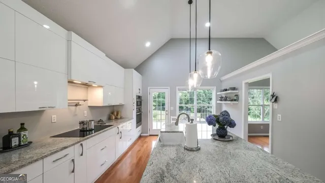 a large kitchen with a table and chairs