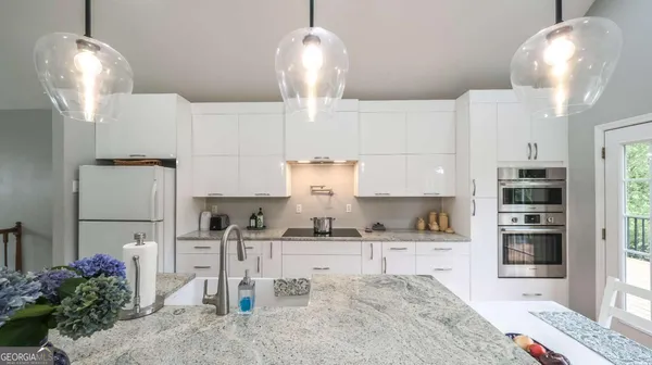 a large kitchen with a table and chairs