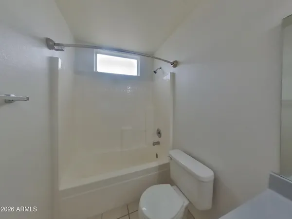a bathroom with a toilet and a bathtub