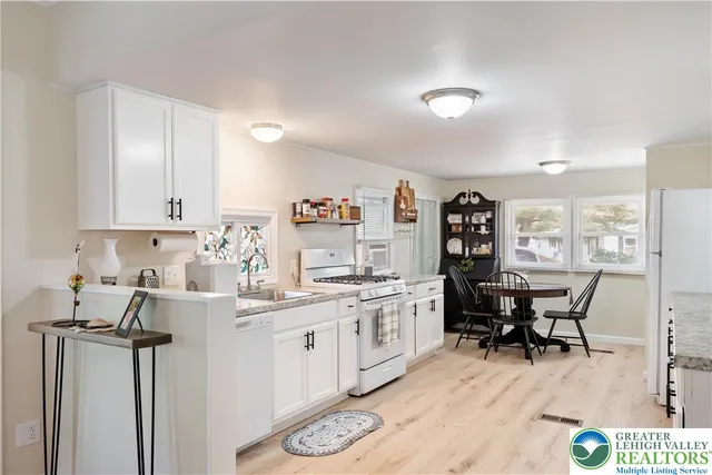 a kitchen with stainless steel appliances kitchen island granite countertop a sink and cabinets
