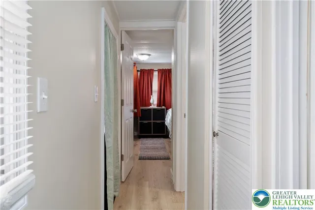 a view of a hallway with wooden shelves