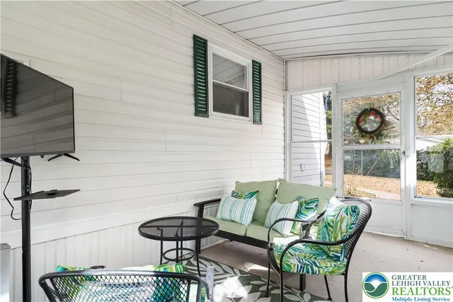 a balcony with furniture and a window