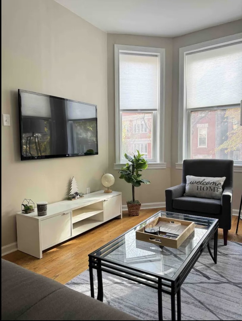 2140 West Crystal Street Chicago, IL 60622 - Photo 2 of 8 a living room with furniture and a flat screen tv