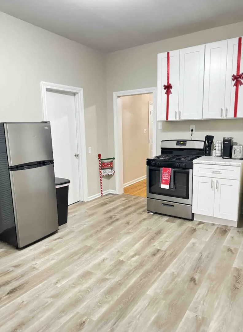 2140 West Crystal Street Chicago, IL 60622 - Photo 4 of 8 a kitchen with stainless steel appliances a stove top oven and a refrigerator