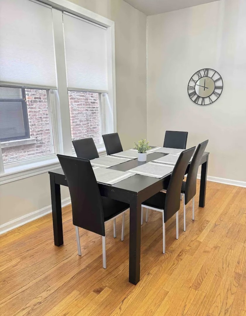 2140 West Crystal Street Chicago, IL 60622 - Photo 6 of 8 a view of a dining room with furniture and wooden floor