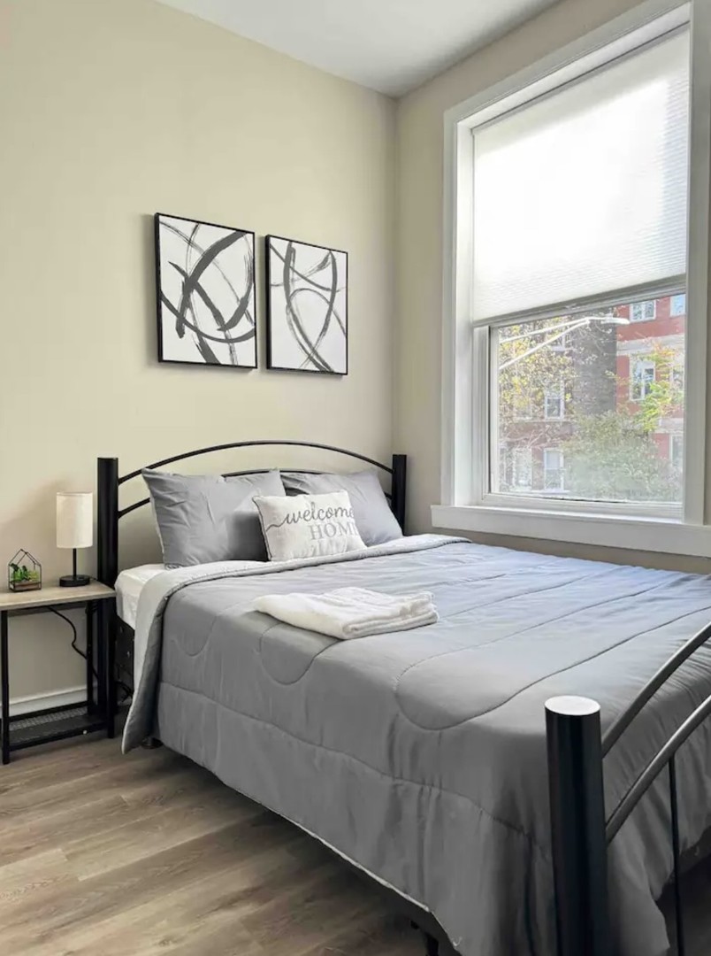 2140 West Crystal Street Chicago, IL 60622 - Photo 7 of 8 a bedroom with a bed and a large window