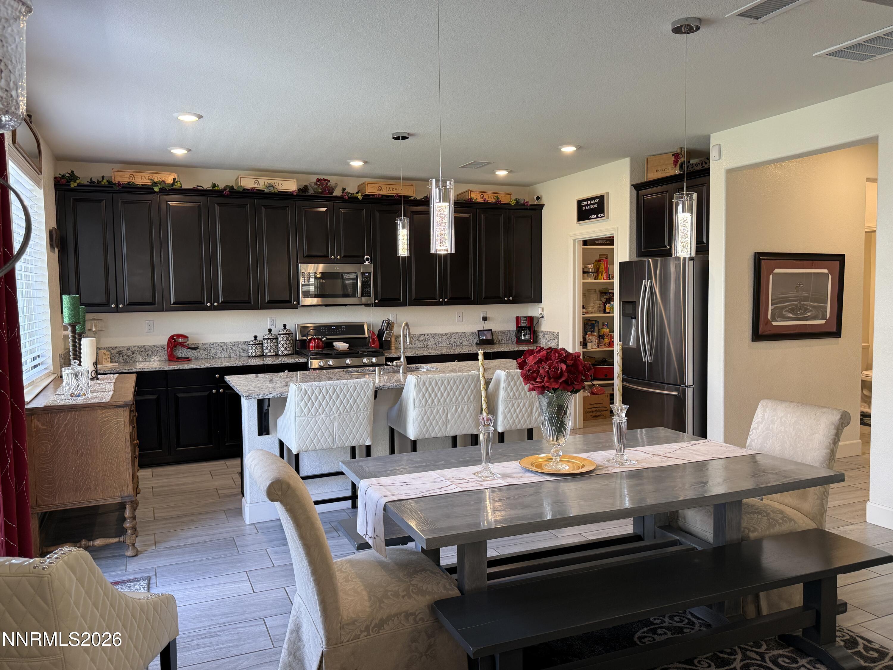 9766 Pachuca Drive Reno, NV 89521 - Photo 12 of 59 a kitchen with a refrigerator and a stove top oven