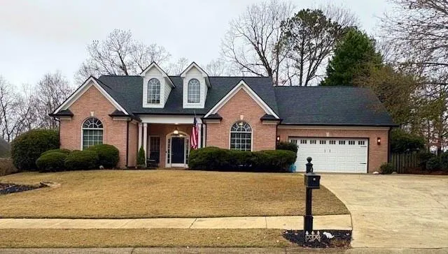 a front view of a house with garden