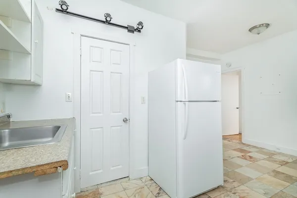 a bathroom with a shower and a sink