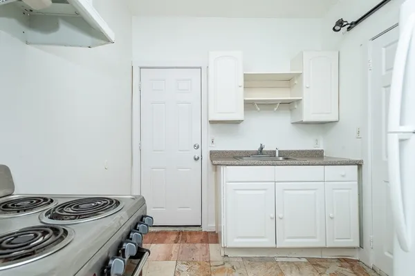 a kitchen with stainless steel appliances granite countertop a sink stove and cabinets