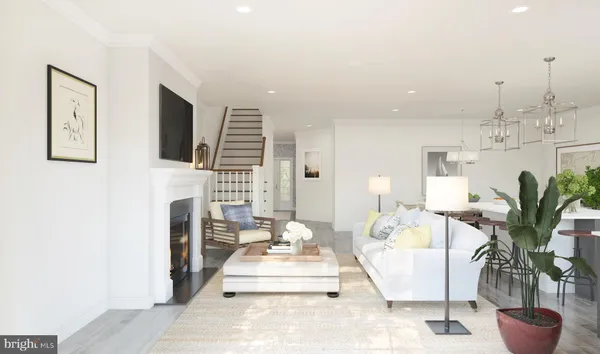 a living room with furniture a fireplace and a potted plant