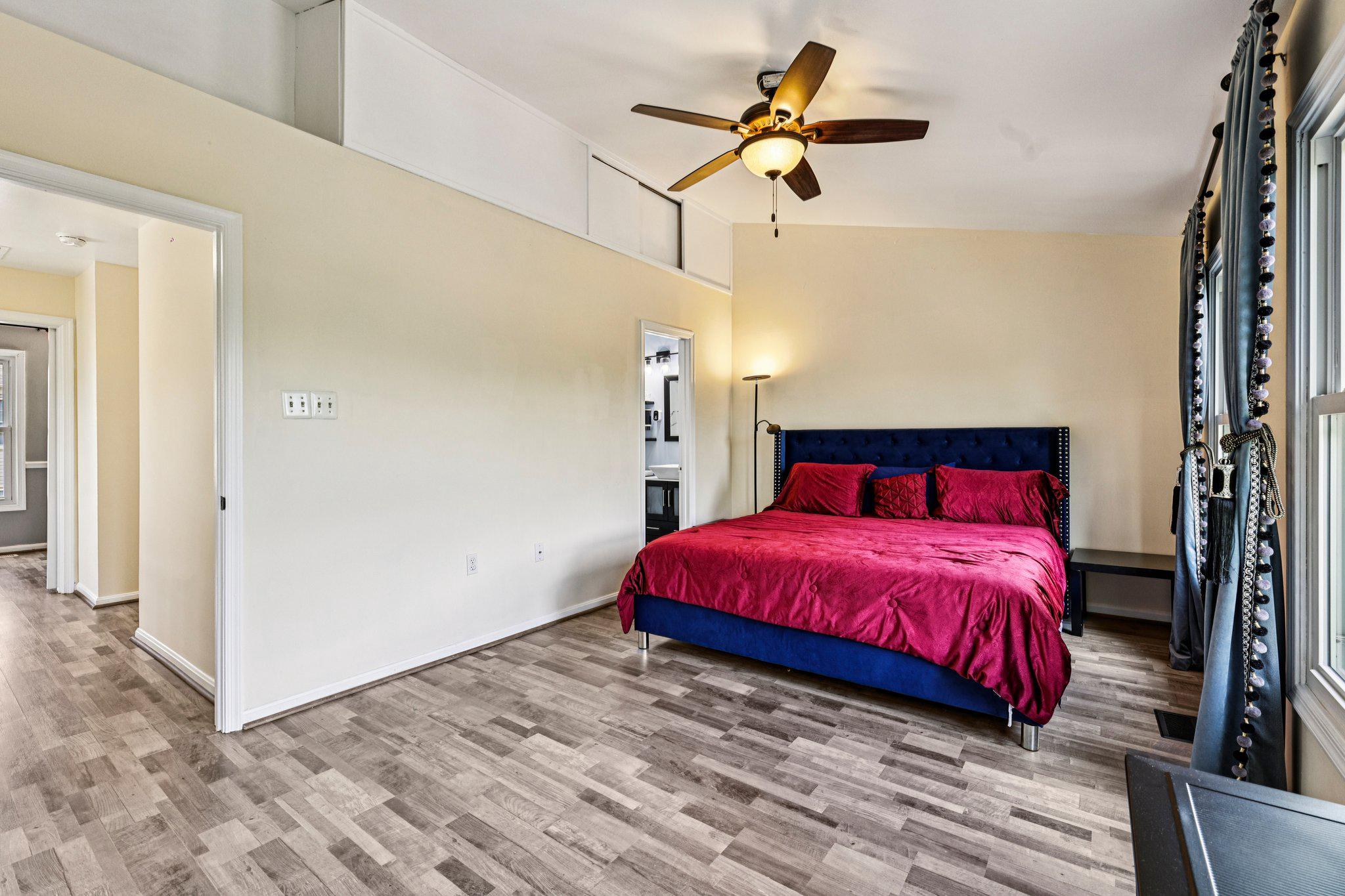 7371 St Thomas Loop Manassas, VA 20109 - Photo 12 of 31 a bedroom with a bed and a chandelier