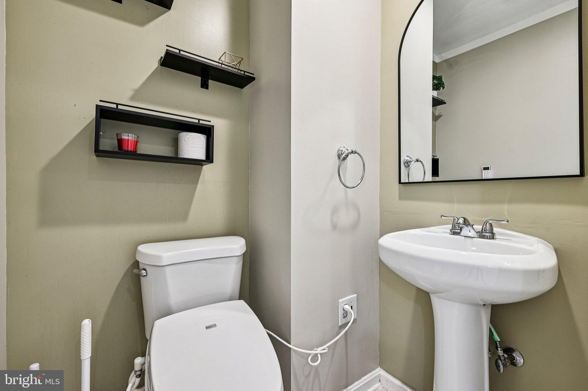 7371 St Thomas Loop Manassas, VA 20109 - Photo 22 of 31 a bathroom with a toilet sink and mirror